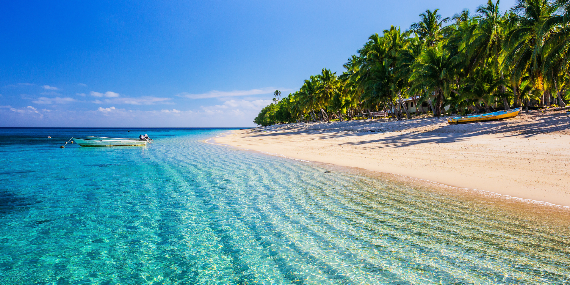 image of blue water and white sand beach